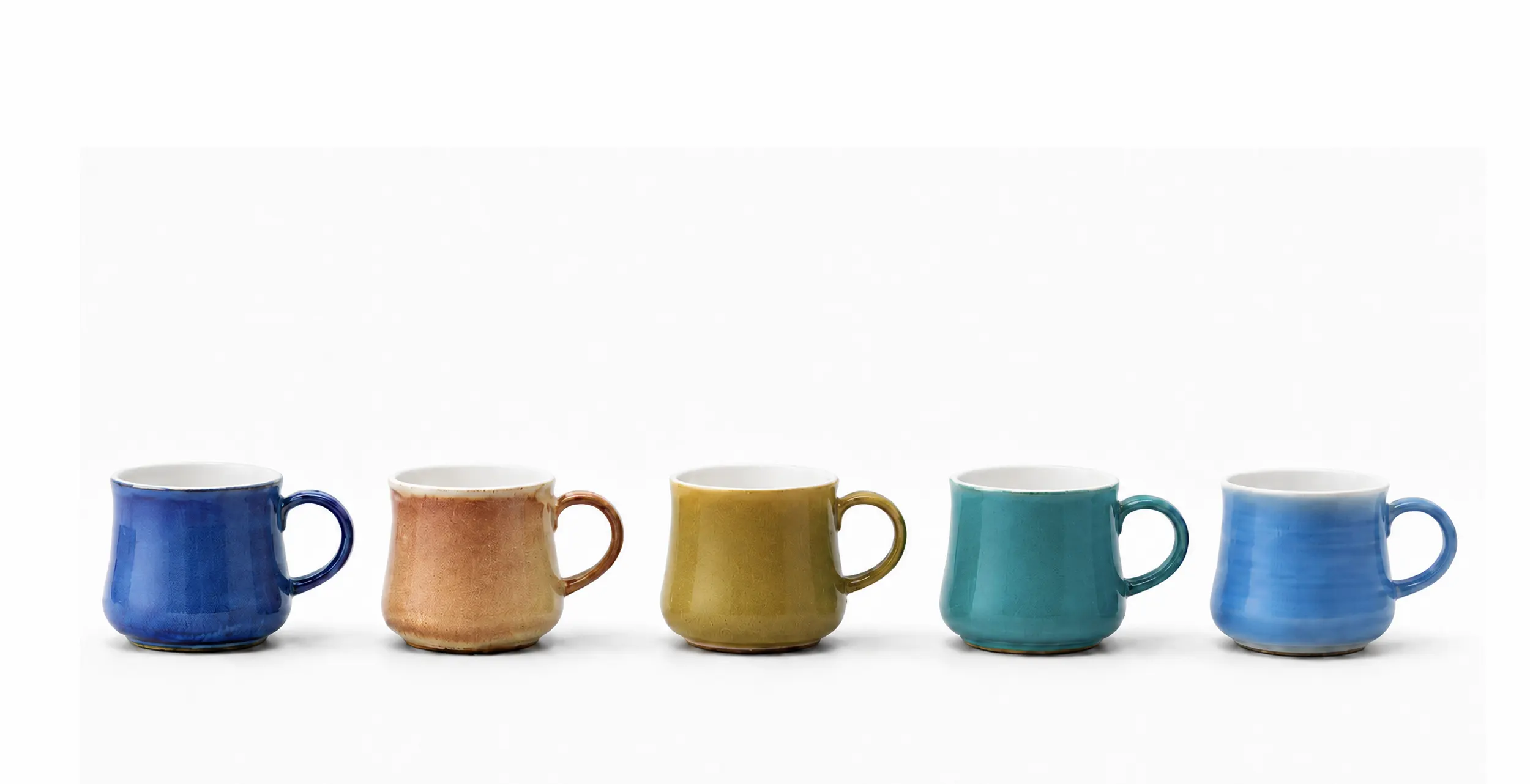 Five hand-thrown ceramic mugs in a row, each finished in a different glaze